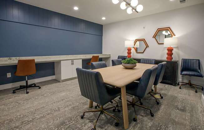 A conference room with a table, chairs, and mirrors.