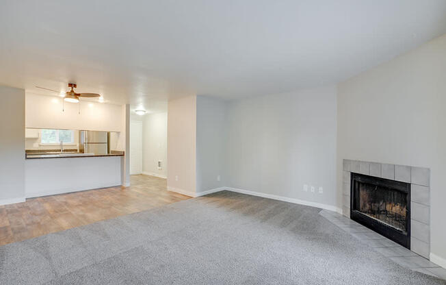 3 BR Apartments in Canby OR - Township - Living Room with Plush Carpeting and an Interior Fireplace