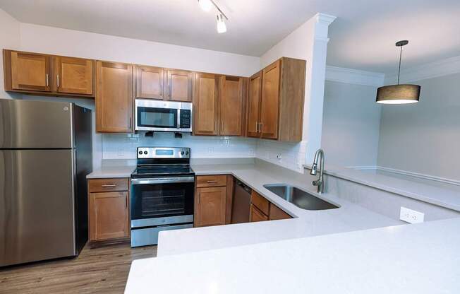A kitchen with wooden cabinets and stainless steel appliances.