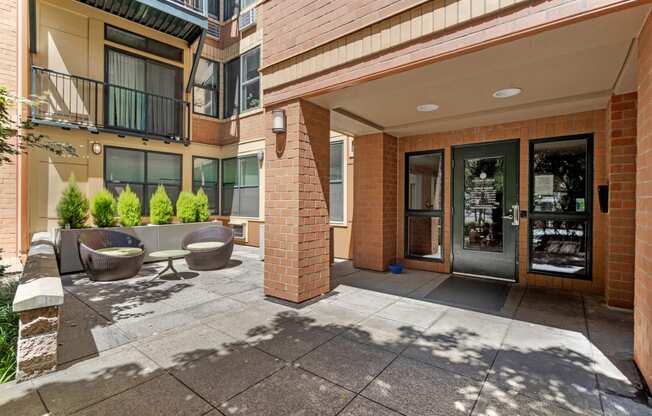 the preserve at ballantyne commons apartment entrance with patio and chairs