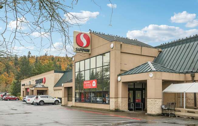 Safeway store with cars parked in front.