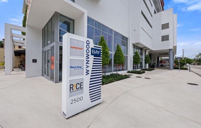 a large white sign in front of a building