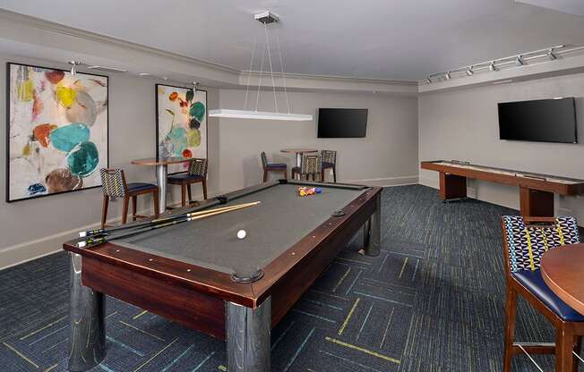 a games room with a pool table and two televisions at The Tribute, Raleigh, North Carolina