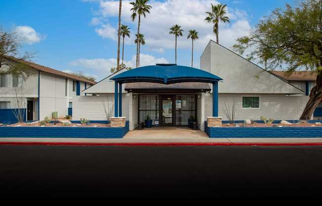 A building with a blue roof and a gate in front.