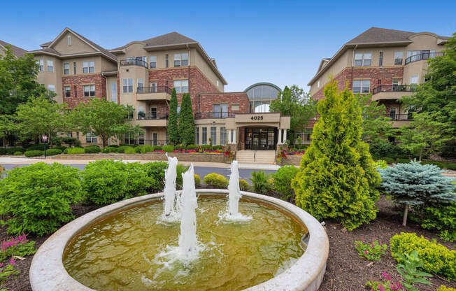 a fountain in front of an apartment building