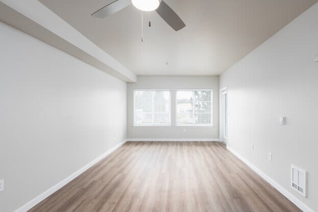 an empty room with a ceiling fan