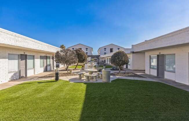 A modern building with a green lawn in front.