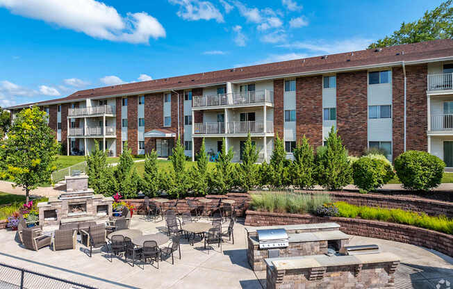 apartment community with a patio grilling area and fire place area for gathering