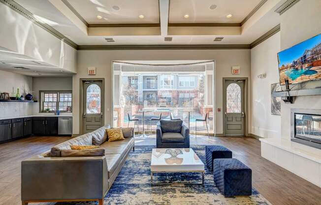 a living room with a couch and a fireplace and a large window