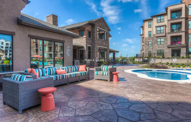 hot tub with couch and clubhouse in background