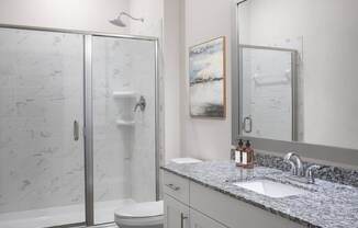 A bathroom with a marble toilet and a sink.
