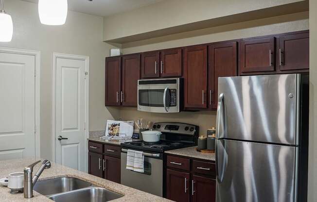 a kitchen with stainless steel appliances and granite counter tops