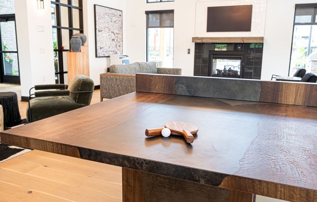 a large communal table in a living room with a fireplace
