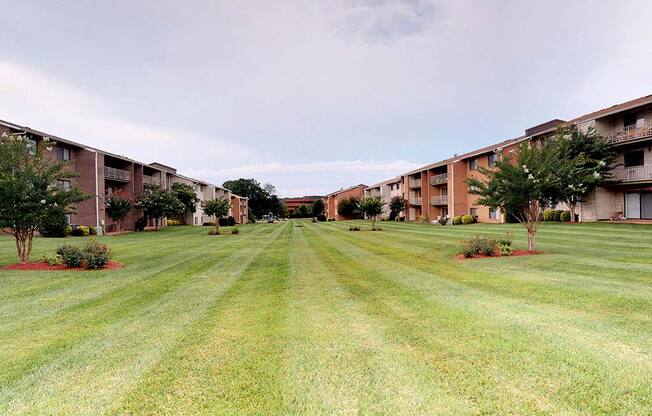 Lawn area with exterior view of apartment complex at Gainsborough Court Apartments, Fairfax