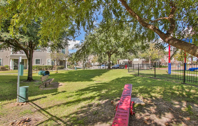 a park with a red picnic table and benches at Sladestone Shadow Creek, Pearland, TX