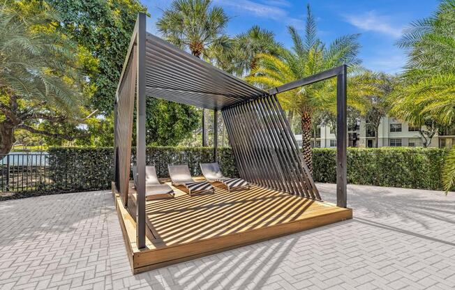 A wooden structure with a metal roof is situated on a patio.