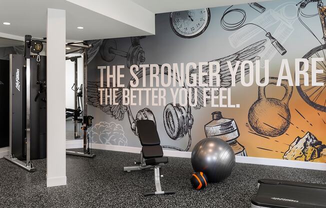 A gym room with a motivational quote on the wall.