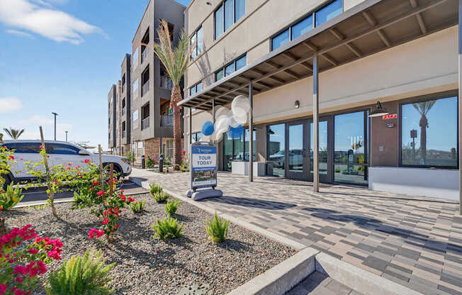 Outside the leasing office with tour sign.