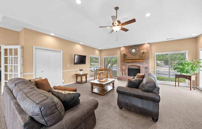 A living room with a grey couch and a fireplace.