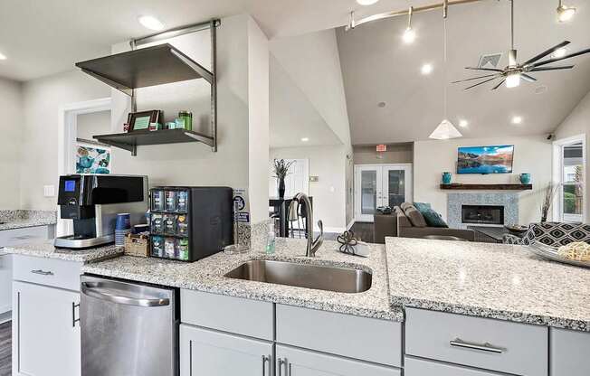 A modern kitchen with granite countertops and stainless steel appliances.