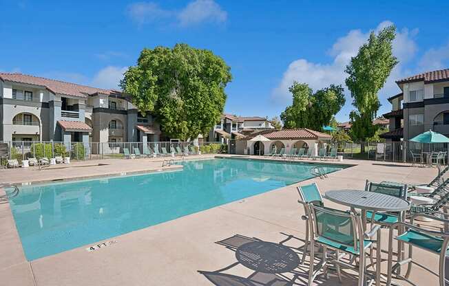 Community Swimming Pool with Pool Furniture at Stillwater Apartments located in Glendale, AZ.