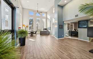 A spacious room with wooden flooring and a ceiling fan.