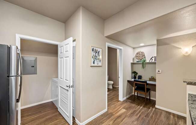 Laundry closet in kitchen and built in desk off kitchen