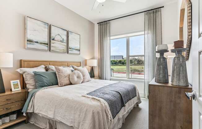 a bedroom with a bed and a large window