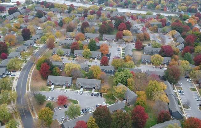 an aerial view of a neighborhood with colorful trees