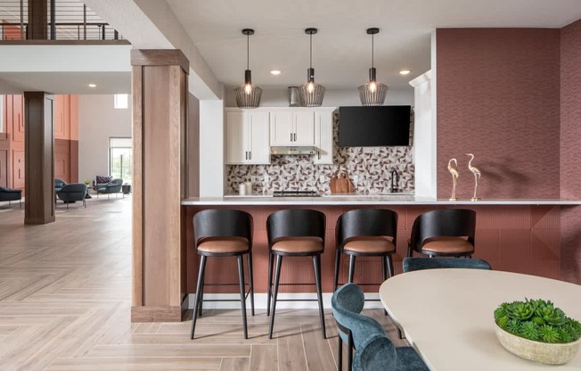 A modern kitchen with a bar area and seating.
