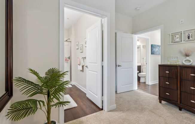 A white door is open to a bathroom.at Century Hampton Roads, Suffolk, VA  