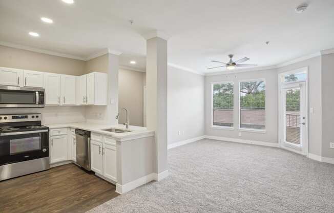 an empty kitchen and living room with a ceiling fan  at The Verandah, Austin, Texas