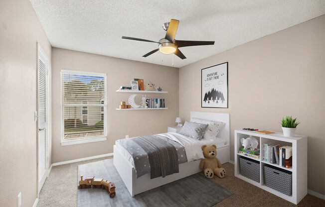 Model bedroom with a bed and a ceiling fan at Vue at Baymeadows Apartments in Jacksonville, Florida