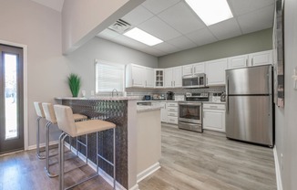 Heathermoor and Bedford Commons kitchen with white cabinets and stainless steel appliances