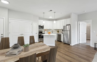 a kitchen and dining room with white cabinets and stainless steel appliances Two Addison Place, Pooler GA