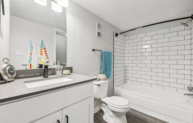 a white bathroom with a sink and a toilet