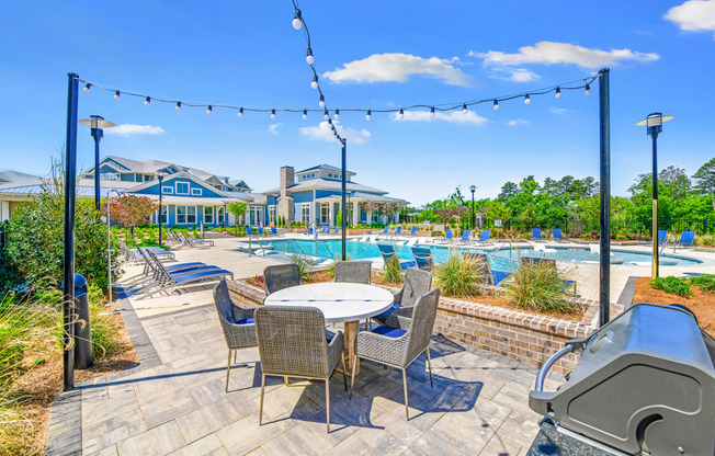 Poolside grilling station and al fresco dining with cafe lights at The Highland in Augusta, GA