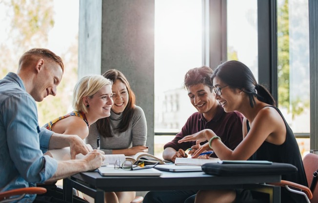 a group of people sitting around a table