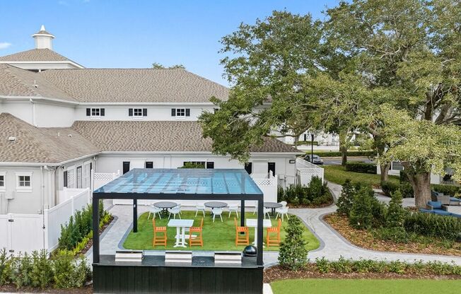 an aerial view of the backyard of a mansion with a garden and a greenhouse