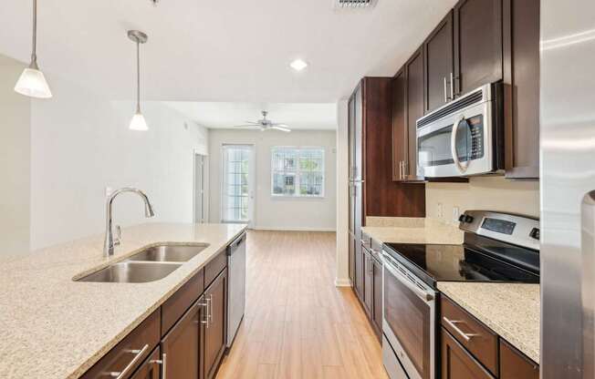 A kitchen with wooden cabinets and a granite countertop.