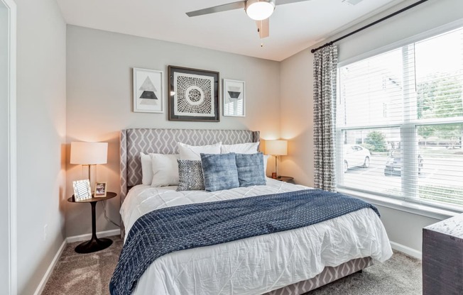 a bedroom with a large bed and a window