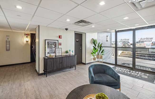 A modern office lobby with a reception desk and a chair.