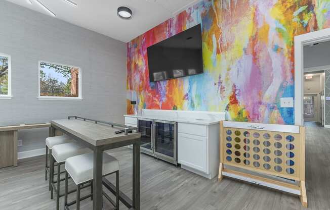 a break room with a table and chairs and a television