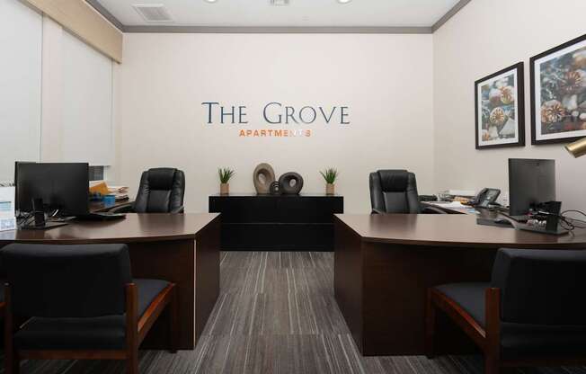 The Grove Apartment has a modern office space with a reception desk and chairs.