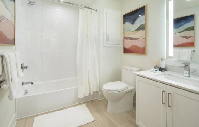 Woodland Hills, CA Luxury Apartments - The Q Variel - Bathroom with Luxury Vinyl Flooring, Spacious Bathtub, and Water Saving Fixtures