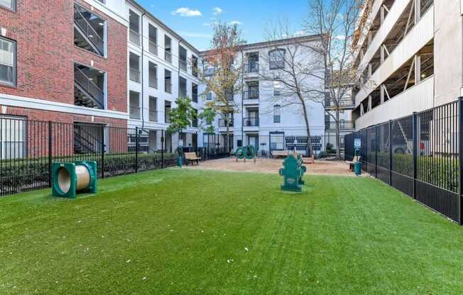 a yard with a fire hydrant in the middle of an apartment building