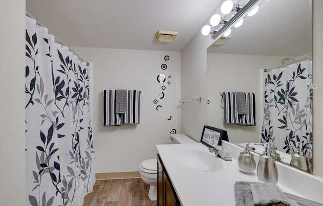 Bathroom in the two-bedroom model unit at Olde English Village, featuring a clean layout with a bathtub and ample storage.