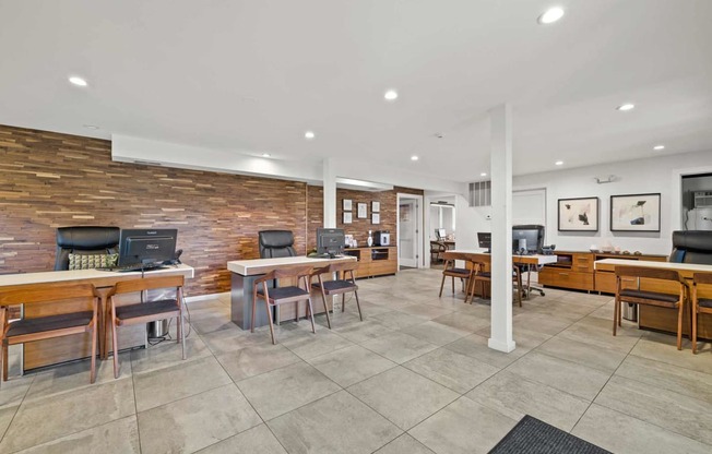 a living room with tables and chairs and a tv