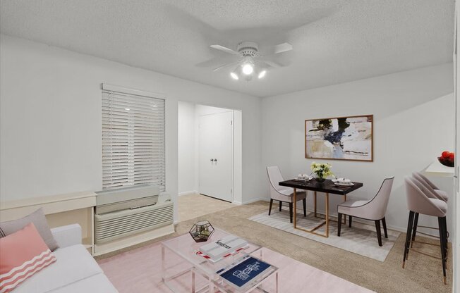 a living room with a dining room table and a ceiling fanat Millcreek Woods Apartments, Olathe, KS, 66061