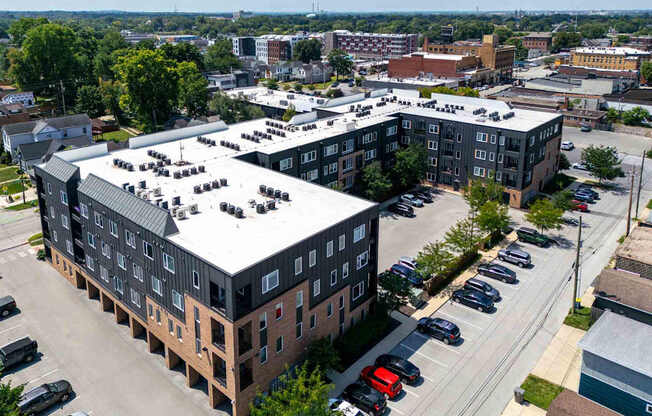 A large multi-story building with a parking lot in front.